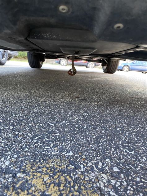 metal sheet hanging under car|metal strip stuck under car.